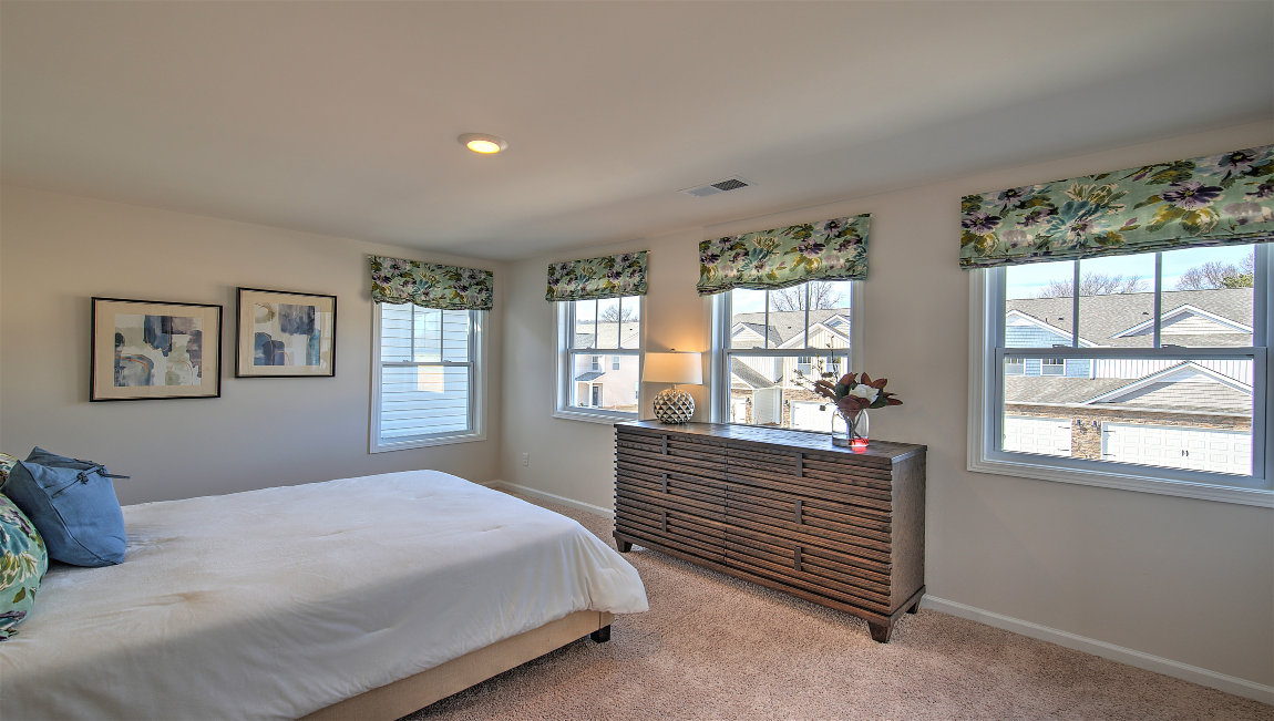 Carpeted bedroom with large window