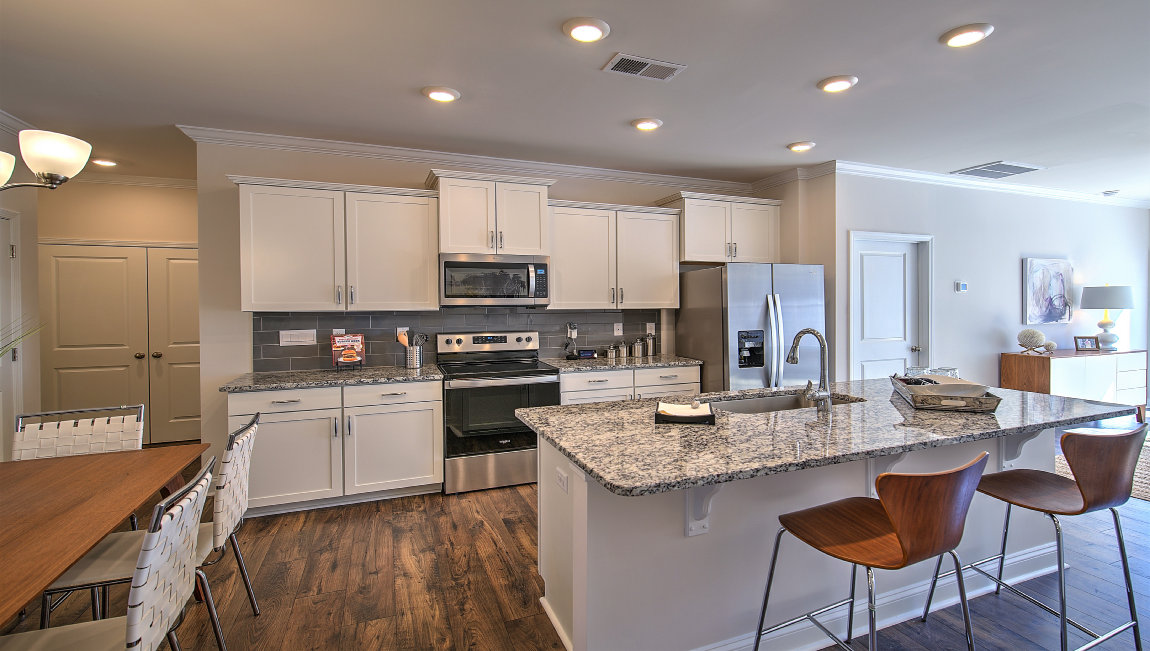 Open kitchen with island and stainless steel appliances