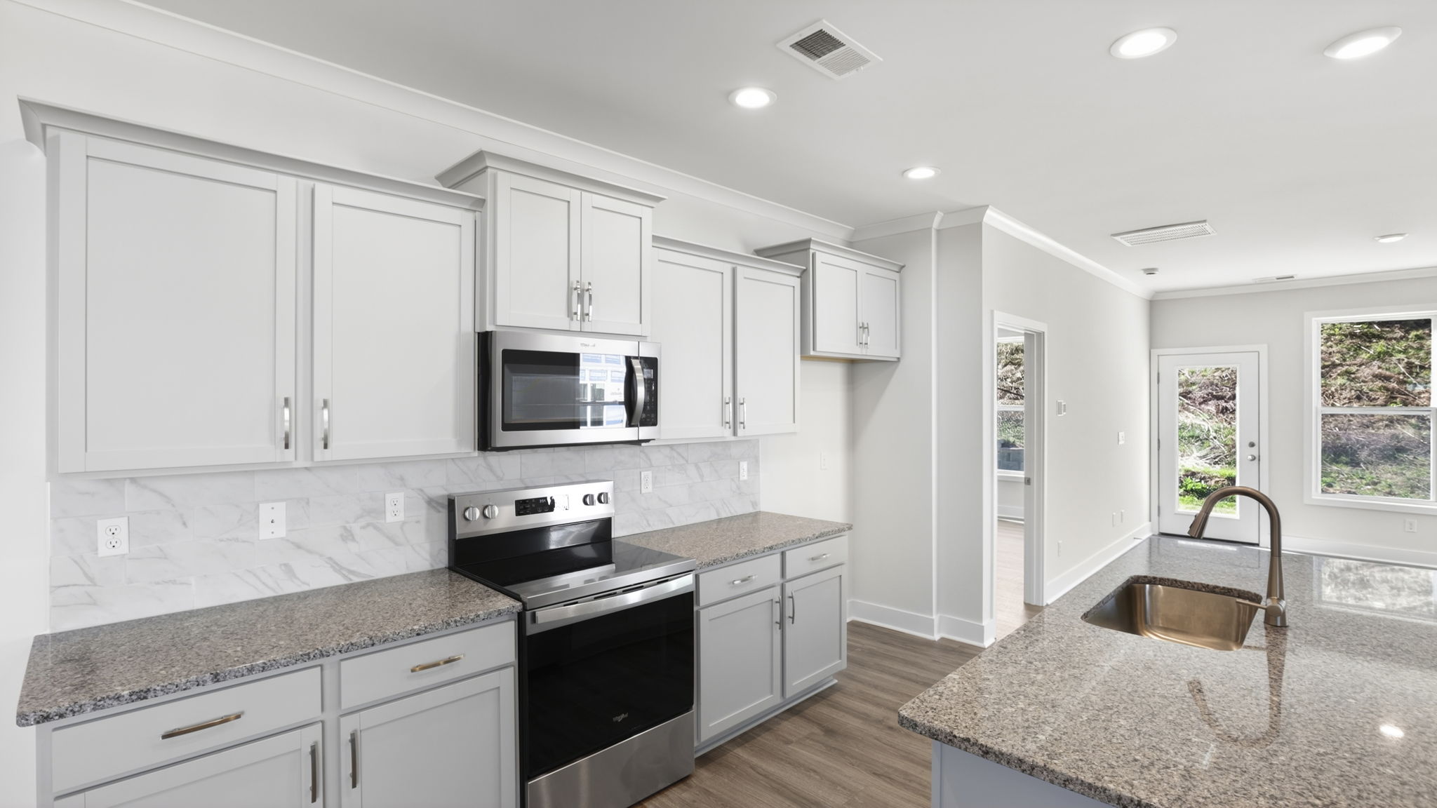 Open concept kitchen with stainless steel appliances and large island