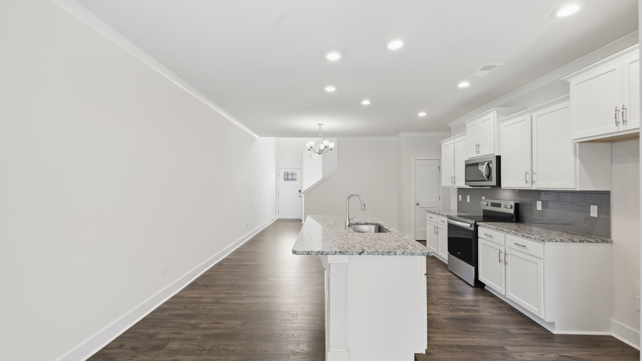 Open concept kitchen with stainless steel appliances and large island