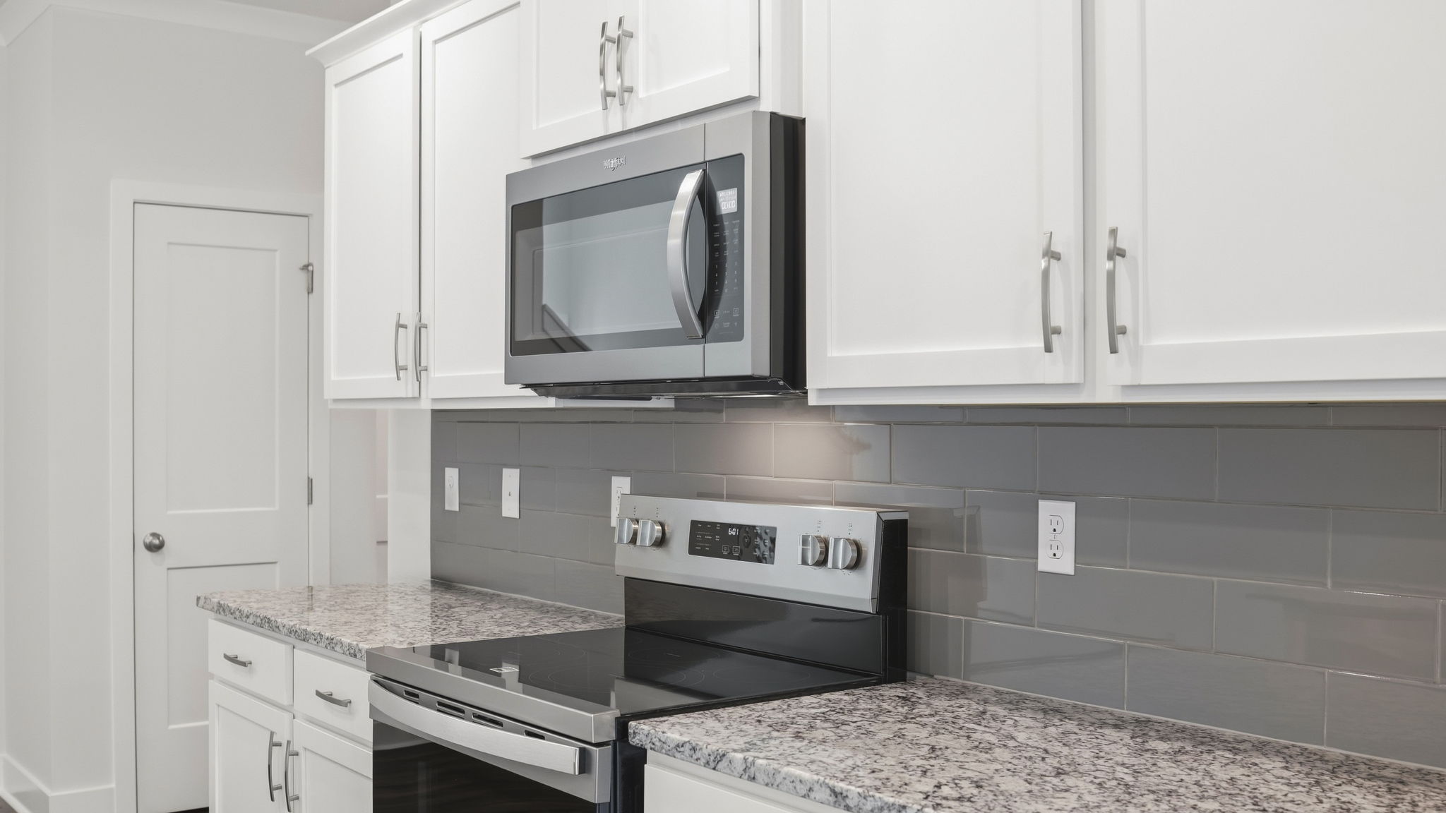 Open concept kitchen with stainless steel appliances and large island