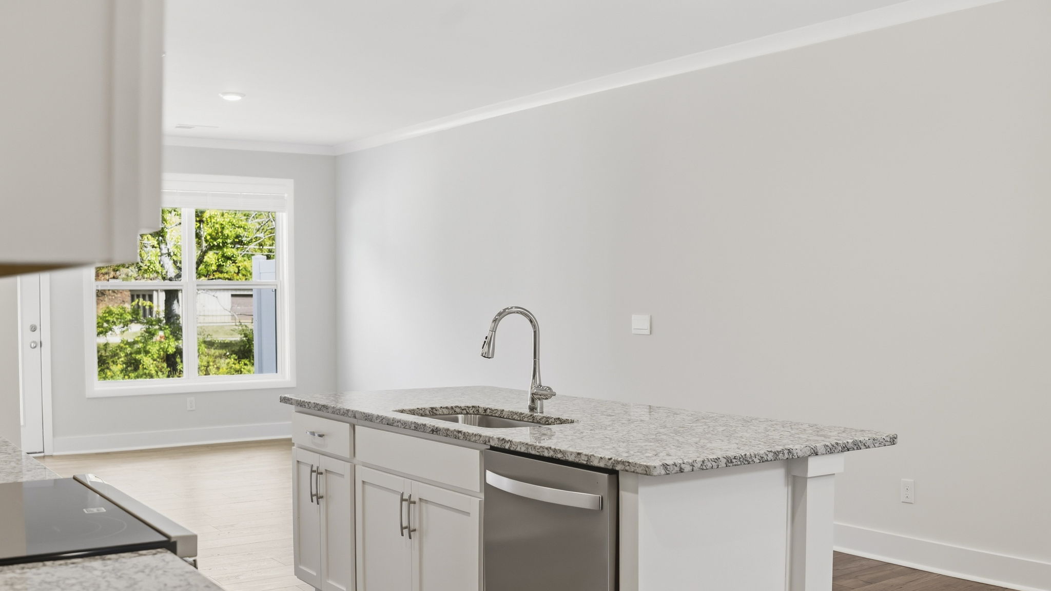 Open concept kitchen with stainless steel appliances and large island