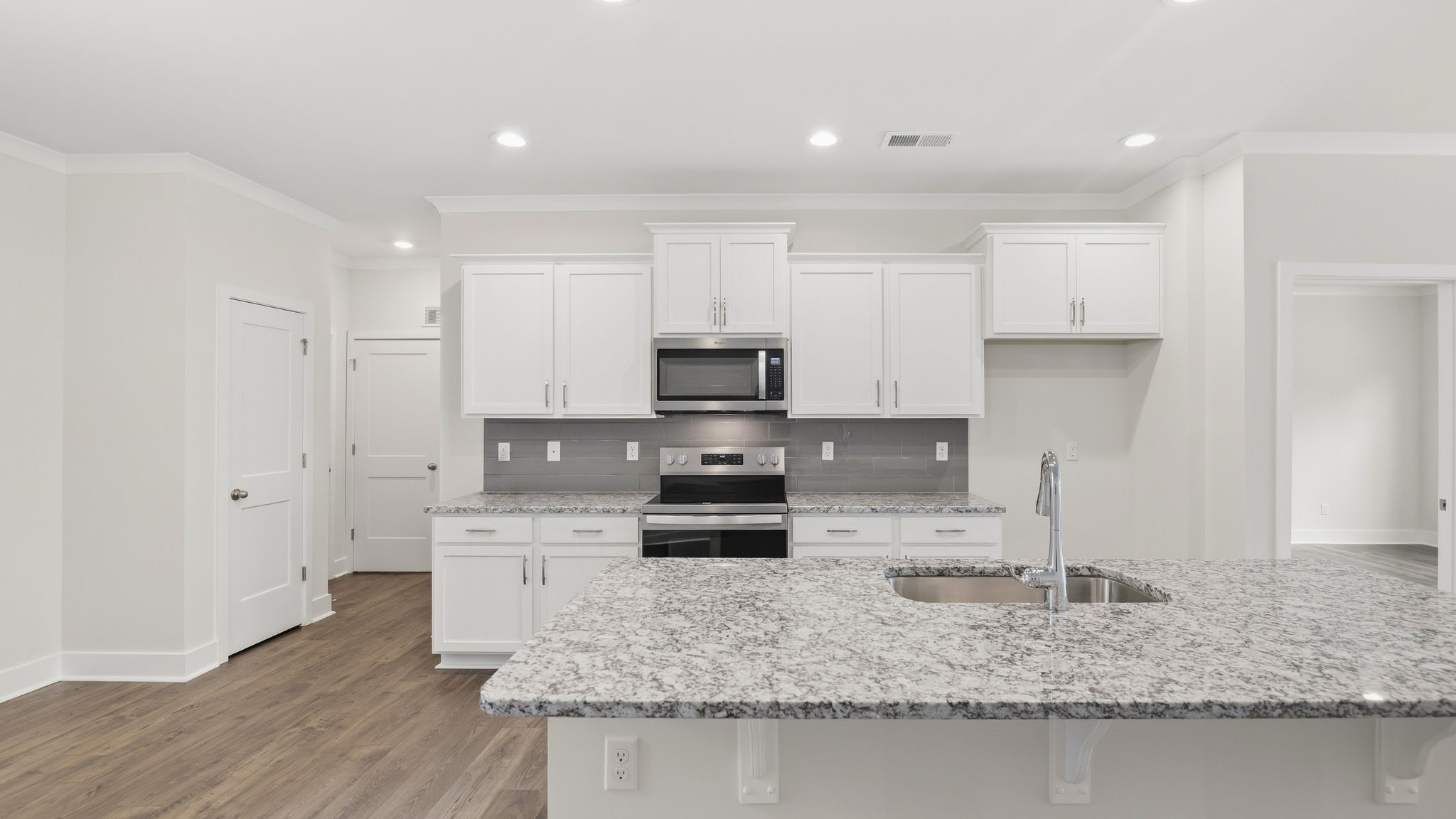 Open concept kitchen with stainless steel appliances and large island