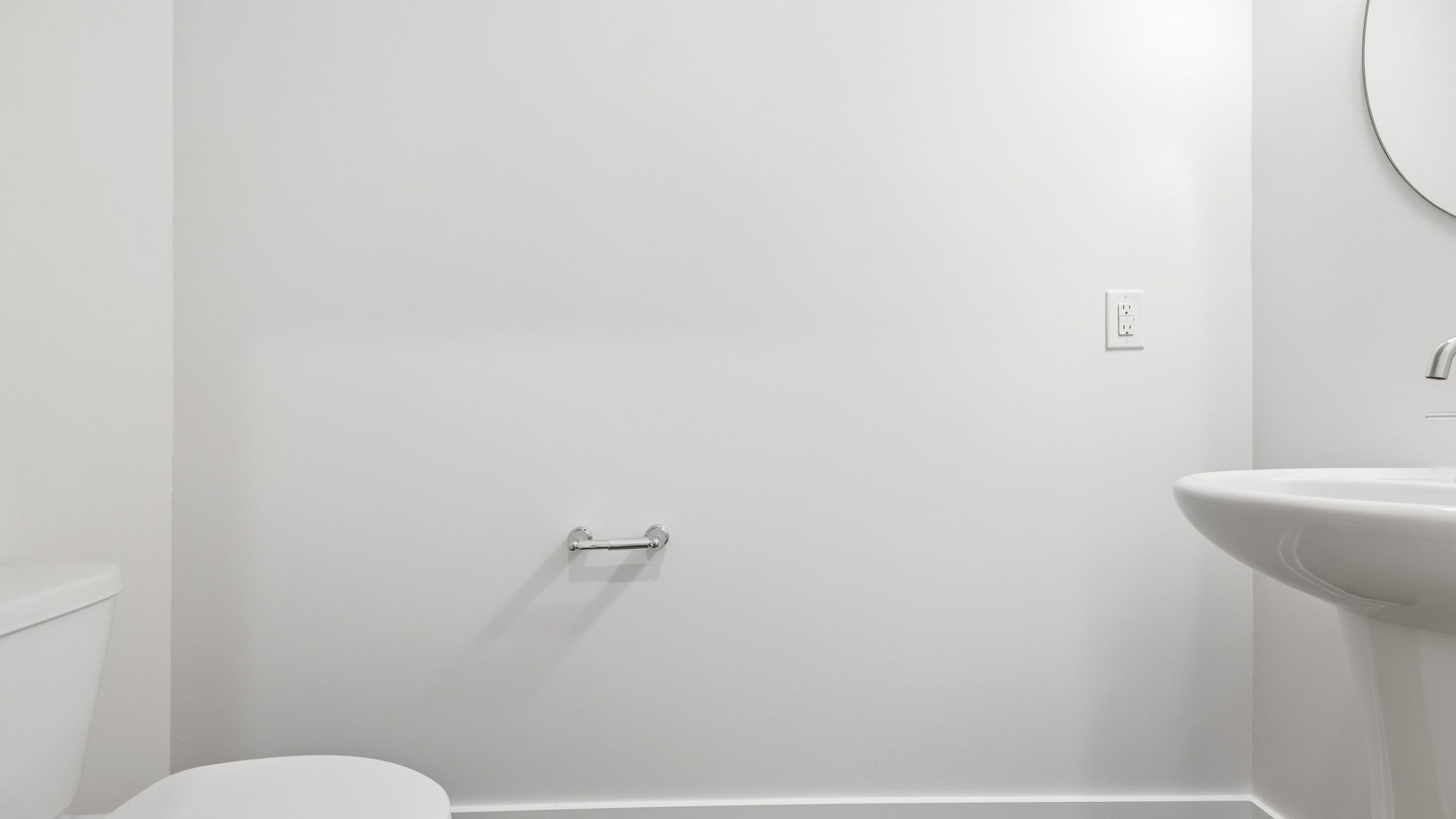 Half bathroom with sink and mirror