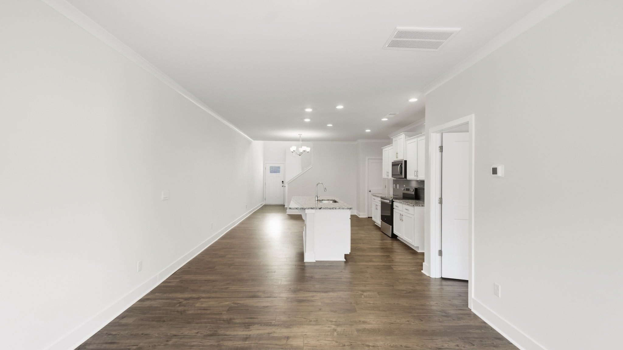 Open concept kitchen with stainless steel appliances and large island
