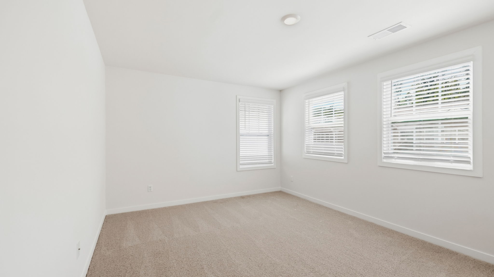 Carpeted bedroom with large windows