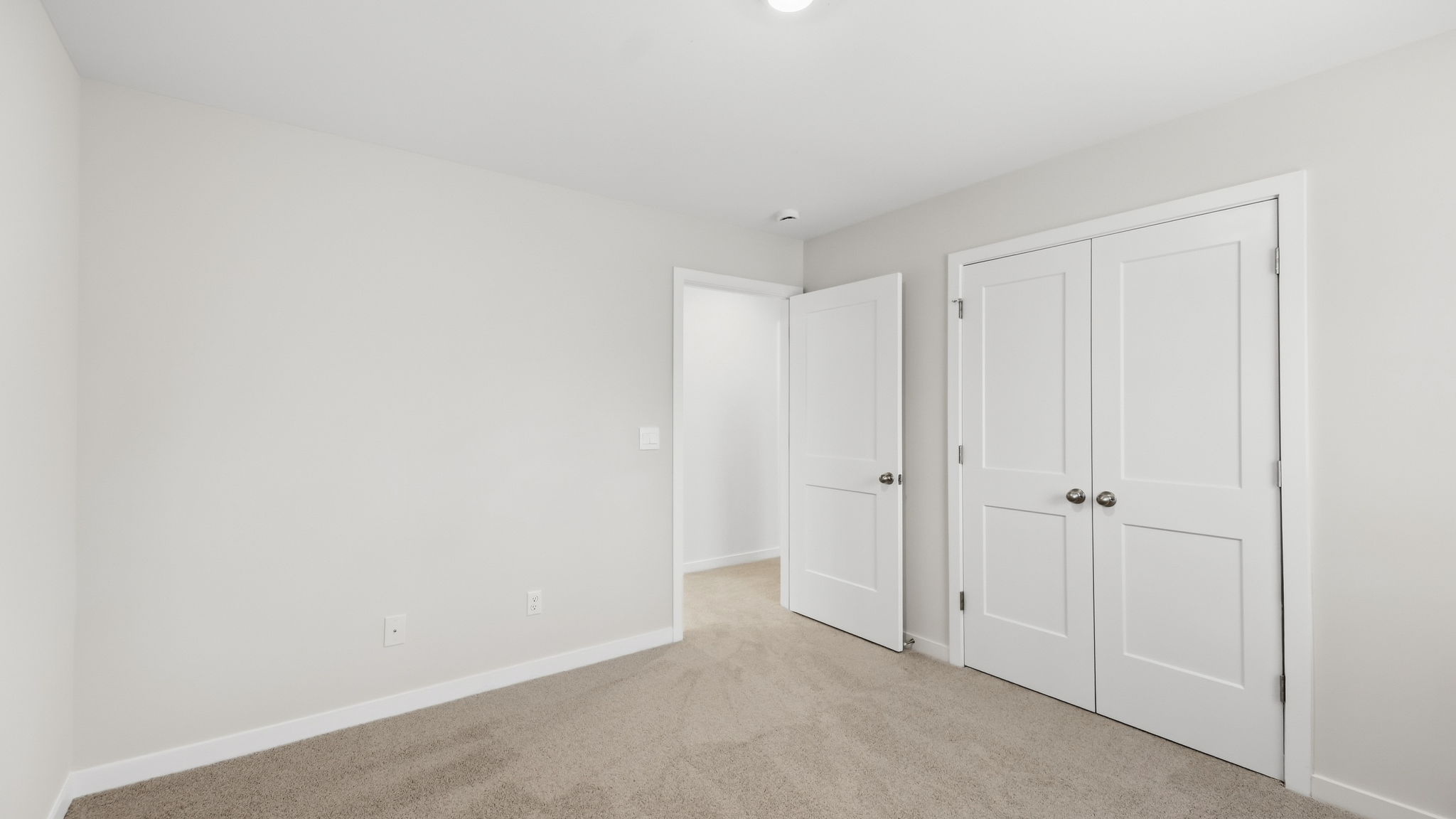 Carpeted bedroom with closet