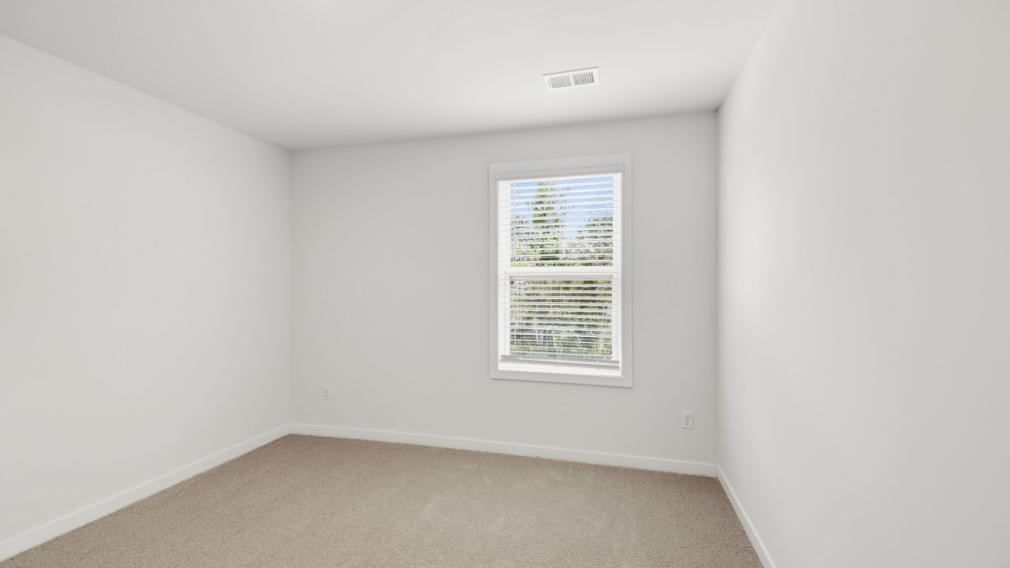 Carpeted bedroom with large windows