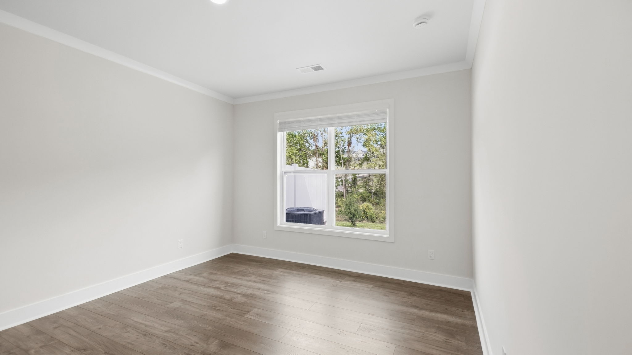 Primary bedroom with large windows