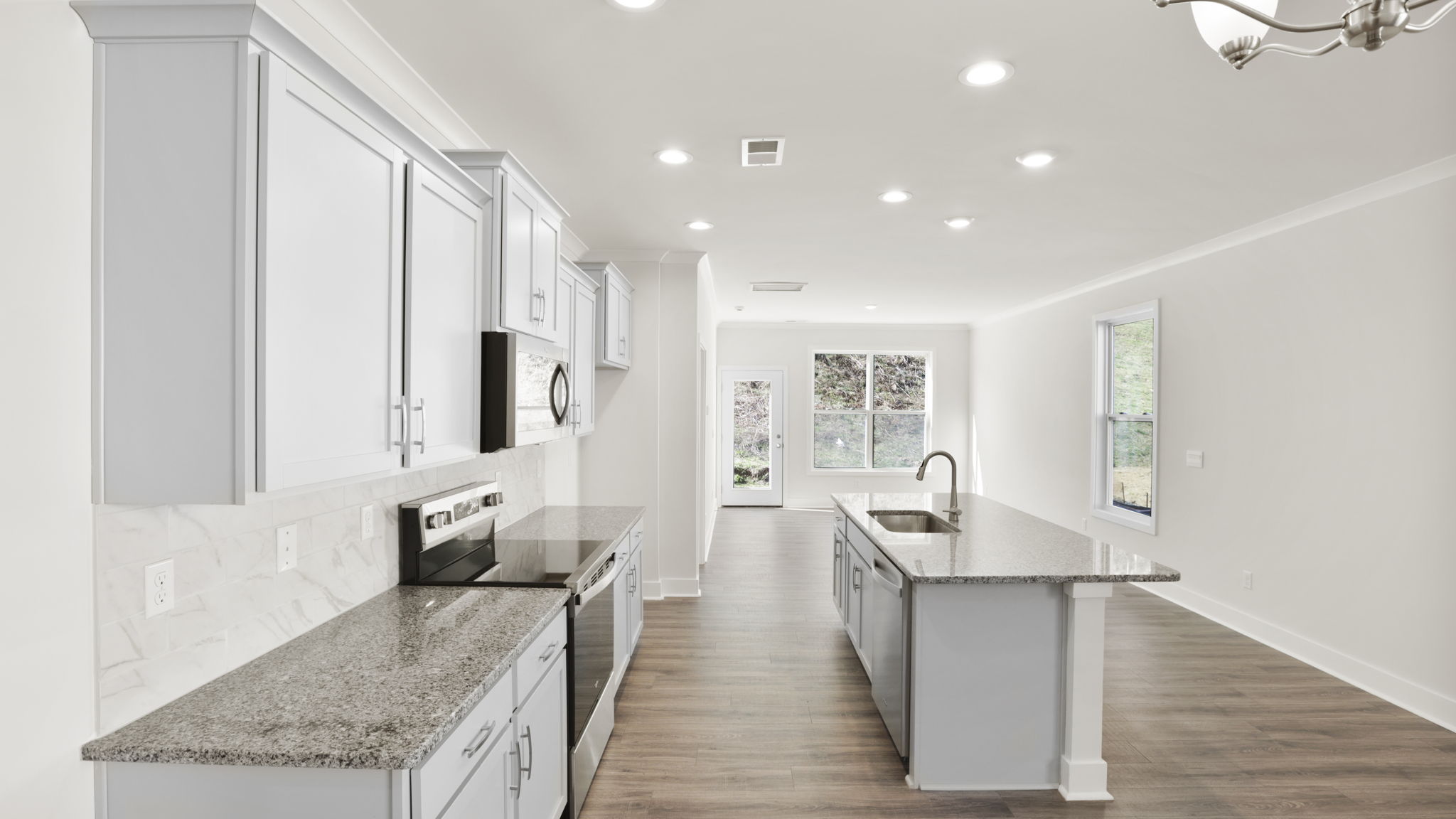 Open concept kitchen with stainless steel appliances and island