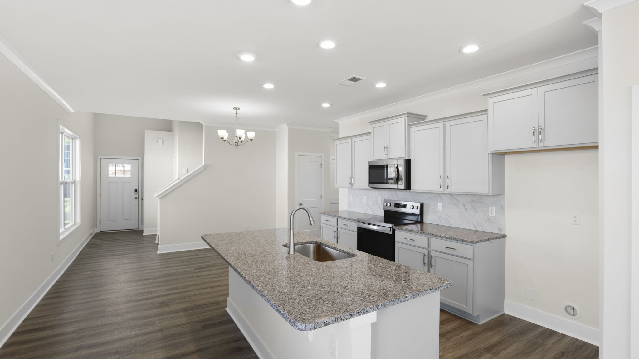 Open concept kitchen with stainless steel appliances and island