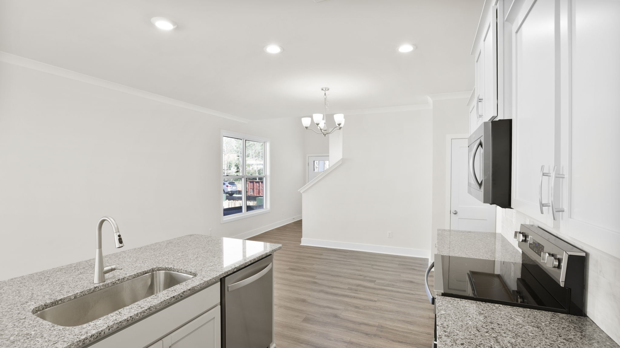 Open concept kitchen with stainless steel appliances and island