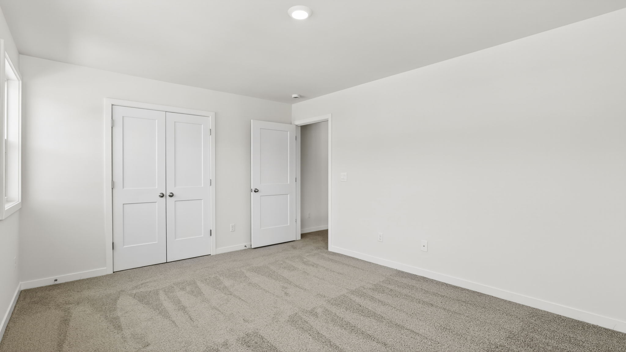 Carpeted bedroom with closet
