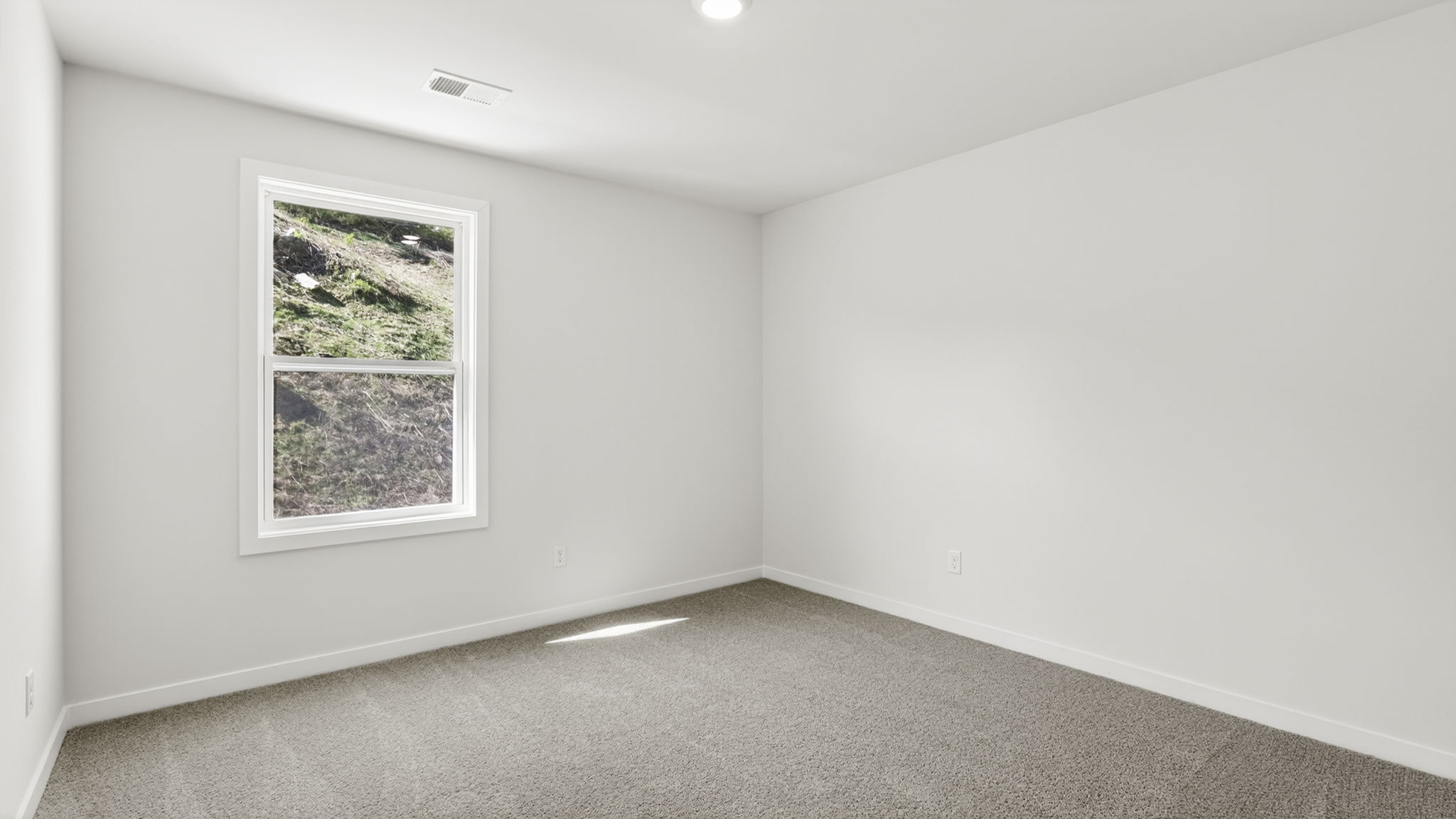 Carpeted bedroom with window