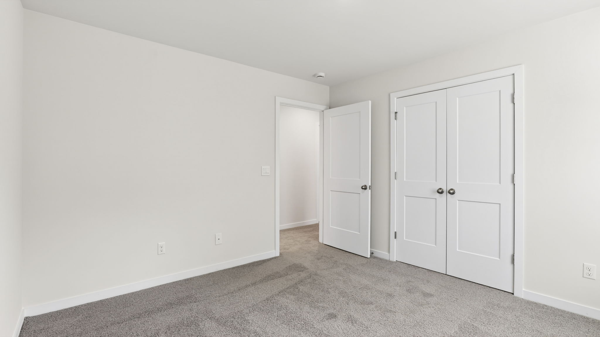 Carpeted bedroom with closet