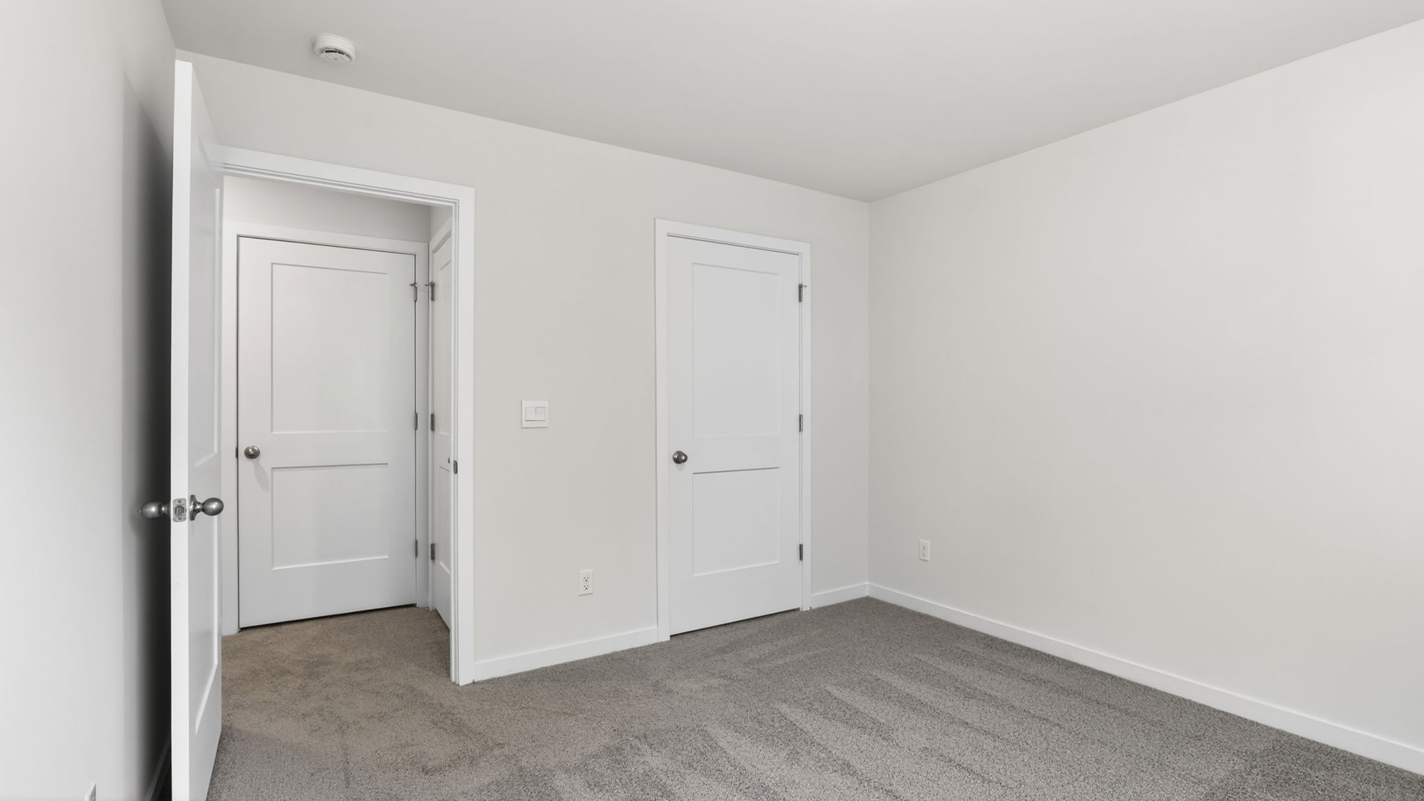 Carpeted bedroom with closet