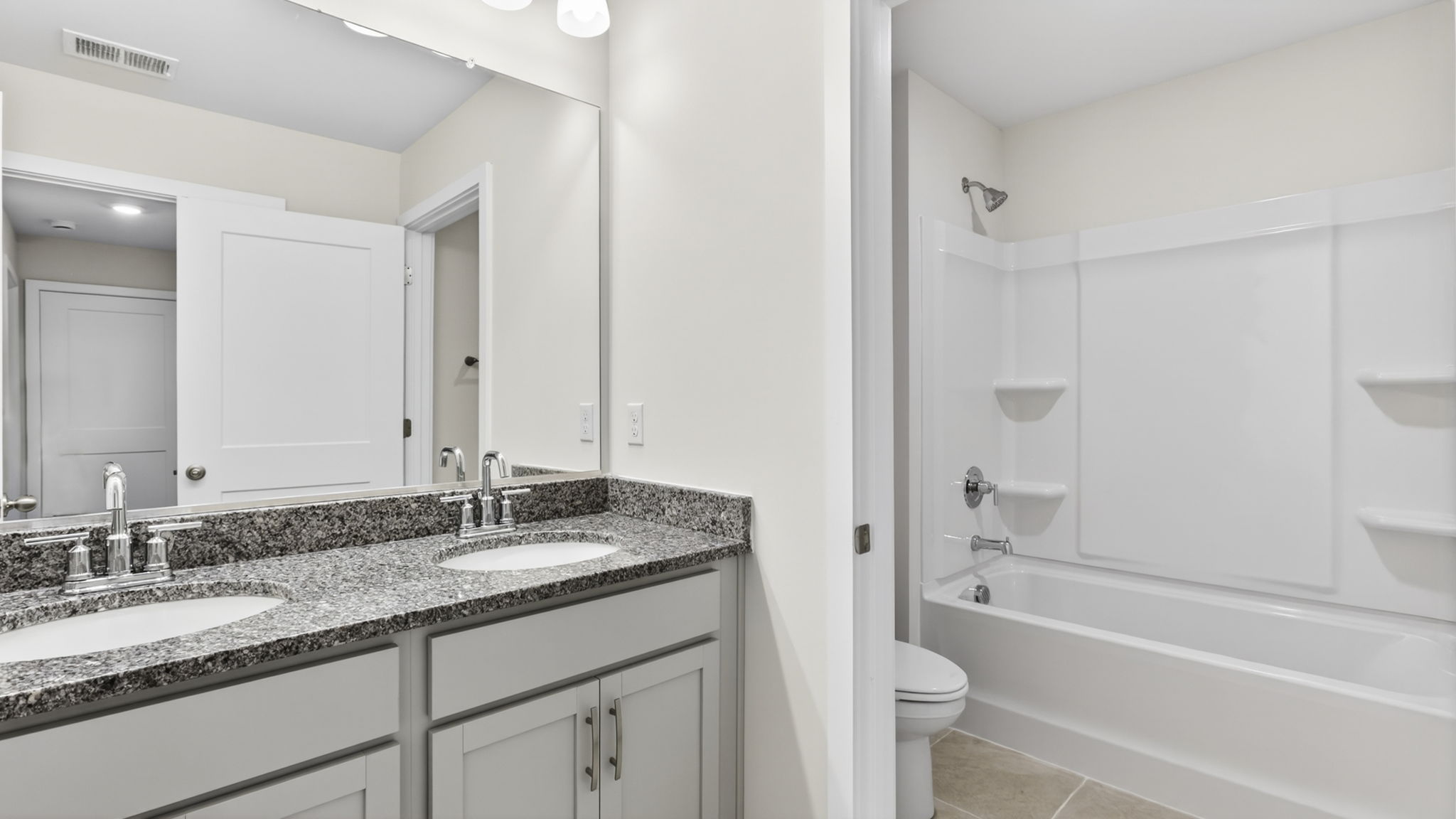 Bathroom with dual vanity and bathtub