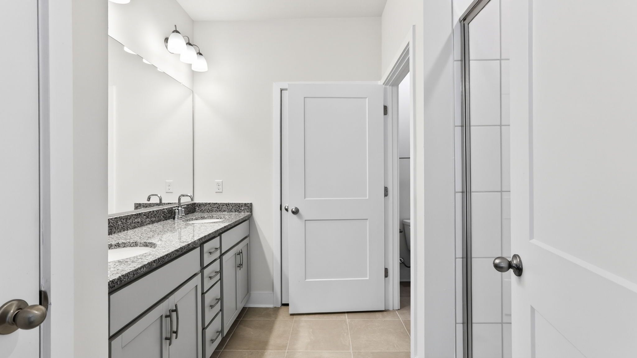 Primary bathroom with dual vanity and walk in shower