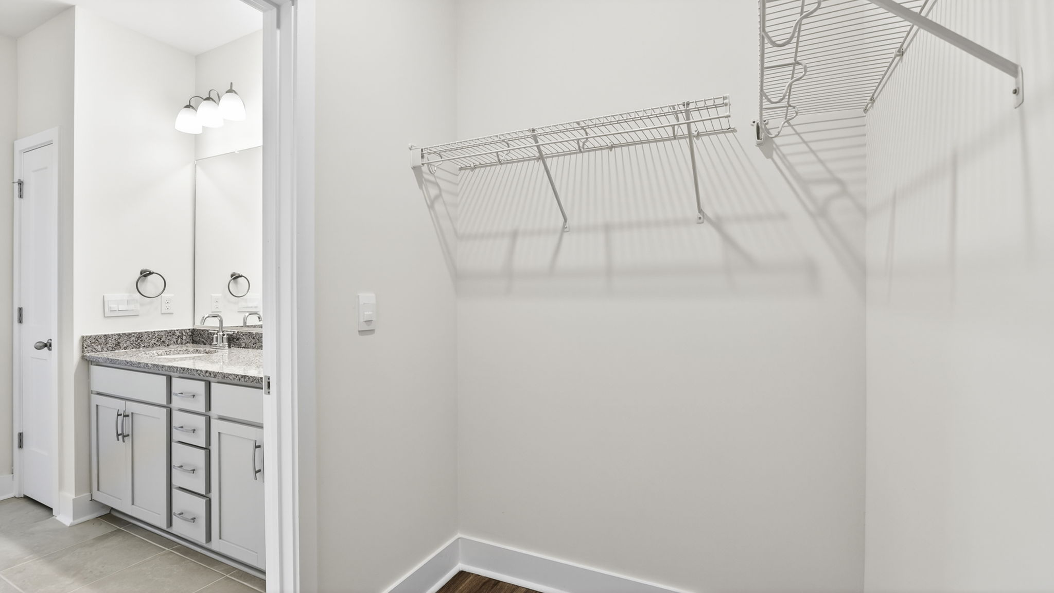 Primary walk in closet with shelving