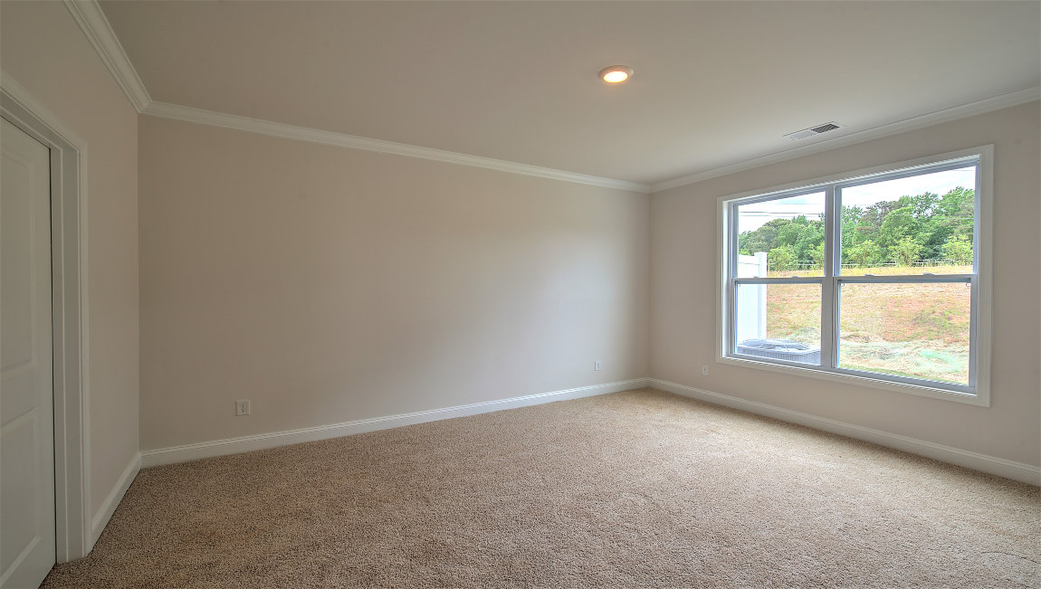 Carpeted bedroom with large window