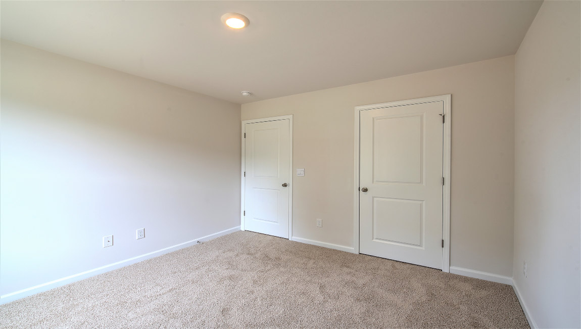 carpeted bedroom with large window