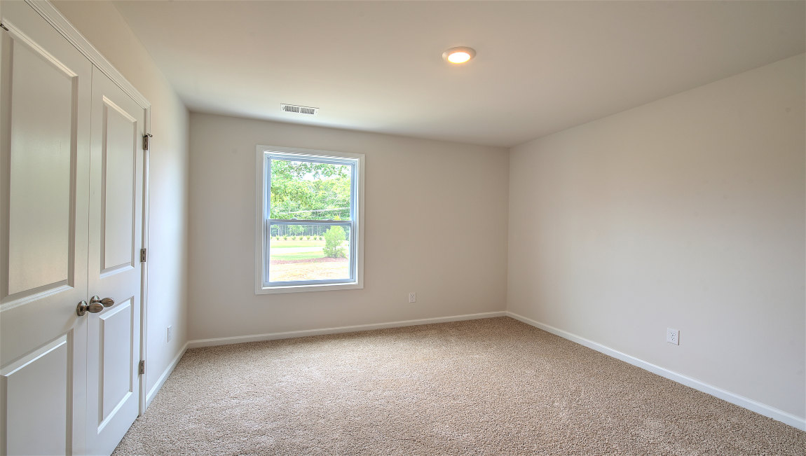 carpeted bedroom with large window