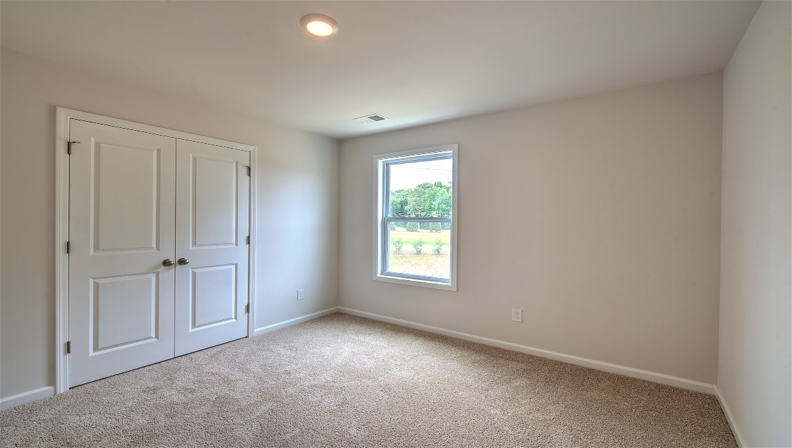 carpeted bedroom with large window