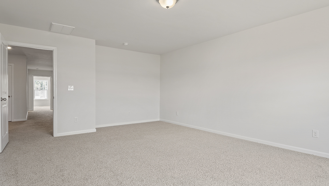 Primary bedroom with carpet, ceiling fan, and large window