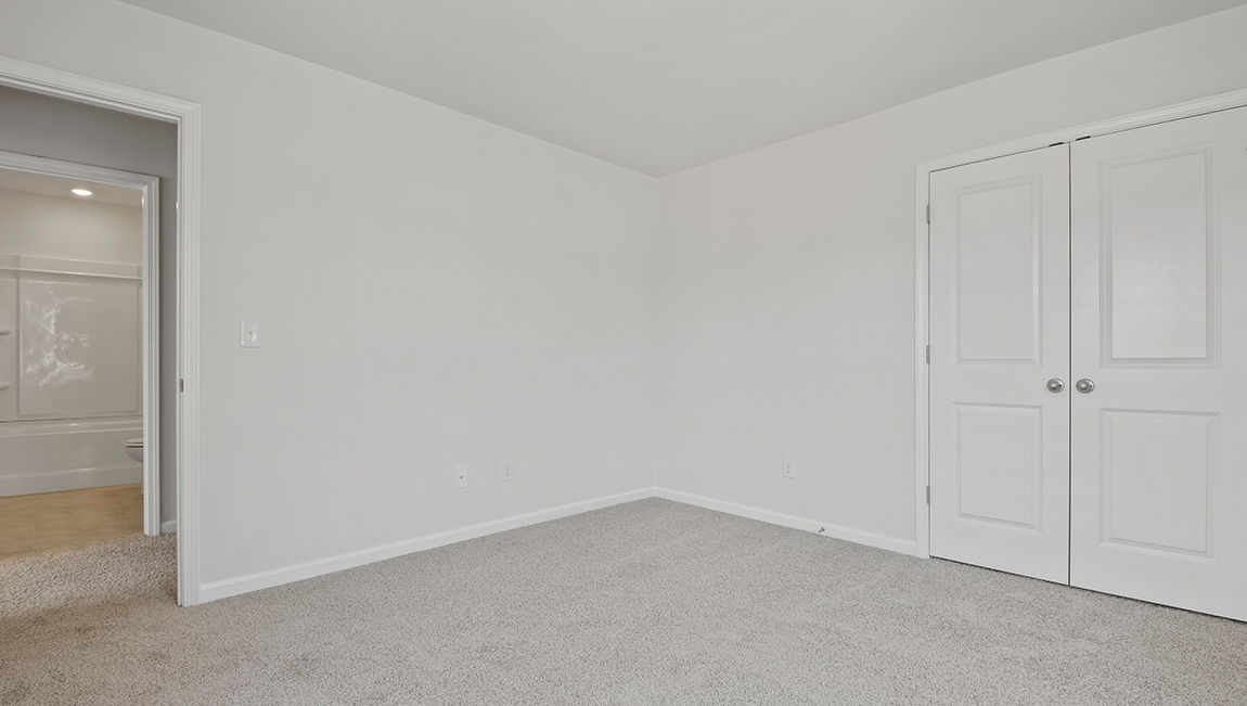 Carpeted bedroom with large window