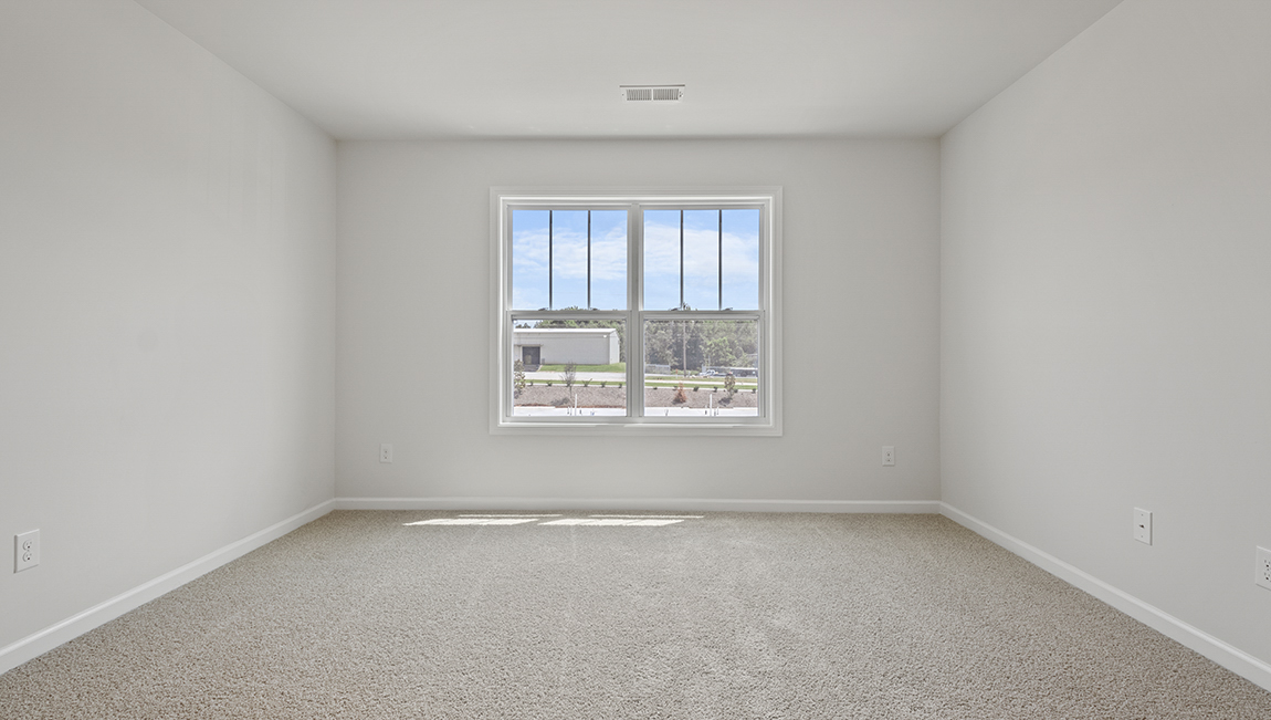 Carpeted bedroom with large window