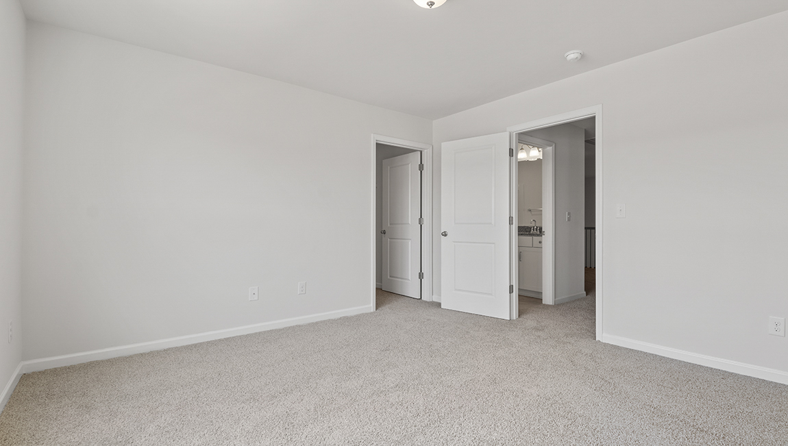 Carpeted bedroom with large window