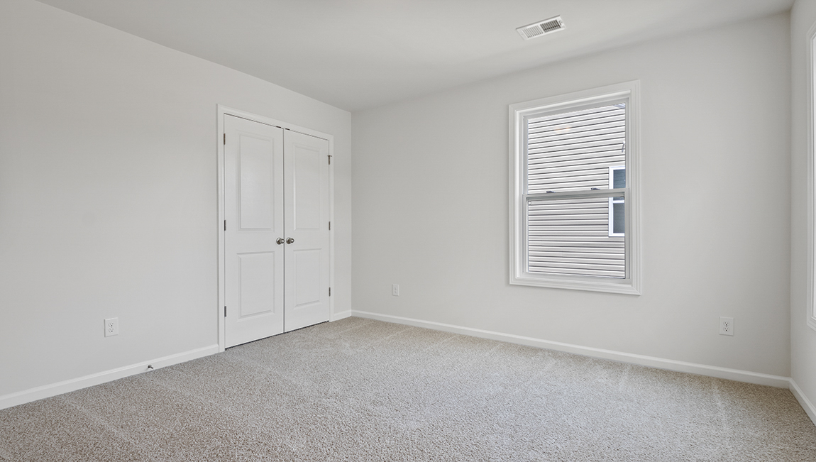 Carpeted bedroom with large window