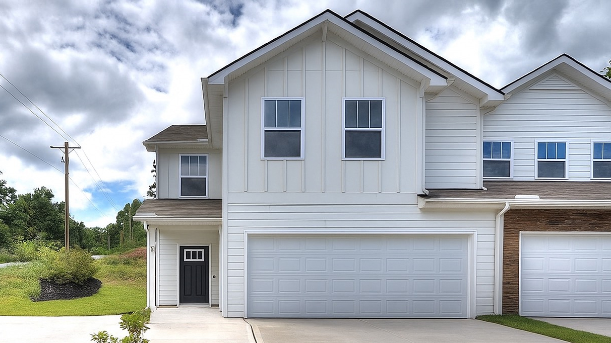 front exterior of a townhome with a one car garage