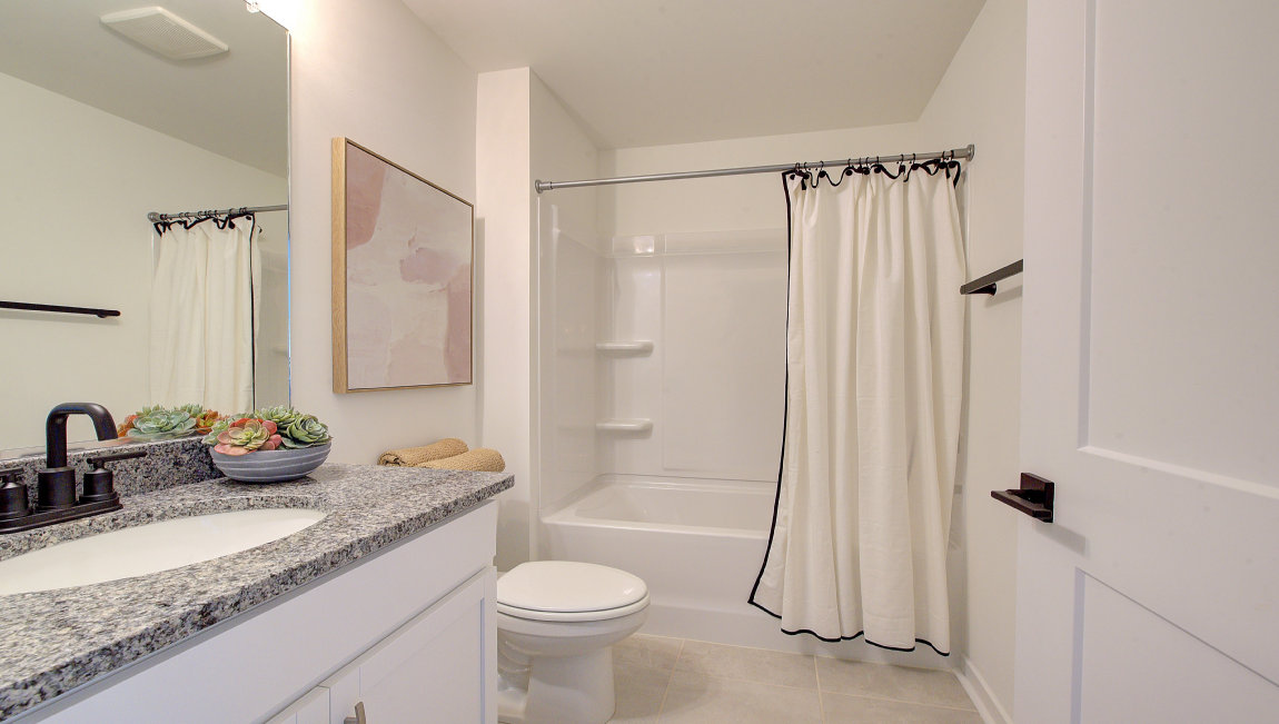 Bathroom with single vanity and bathtub
