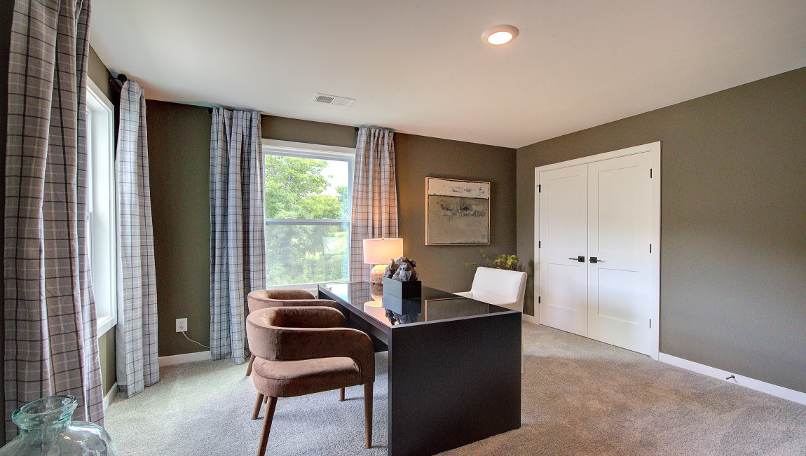 Carpeted bedroom with windows, set as office