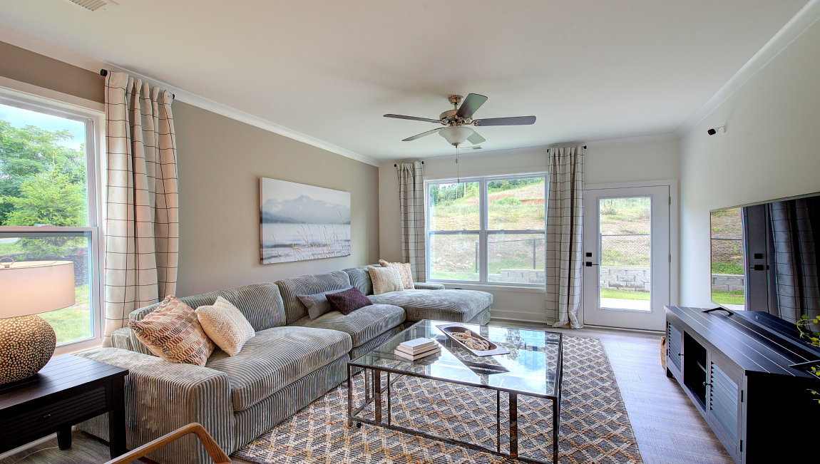Family room with multiple windows and glass door to back yard