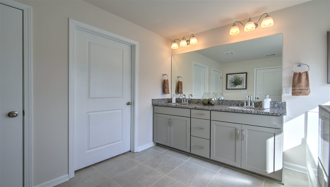 Primary bathtub with dual vanity and walk in closet