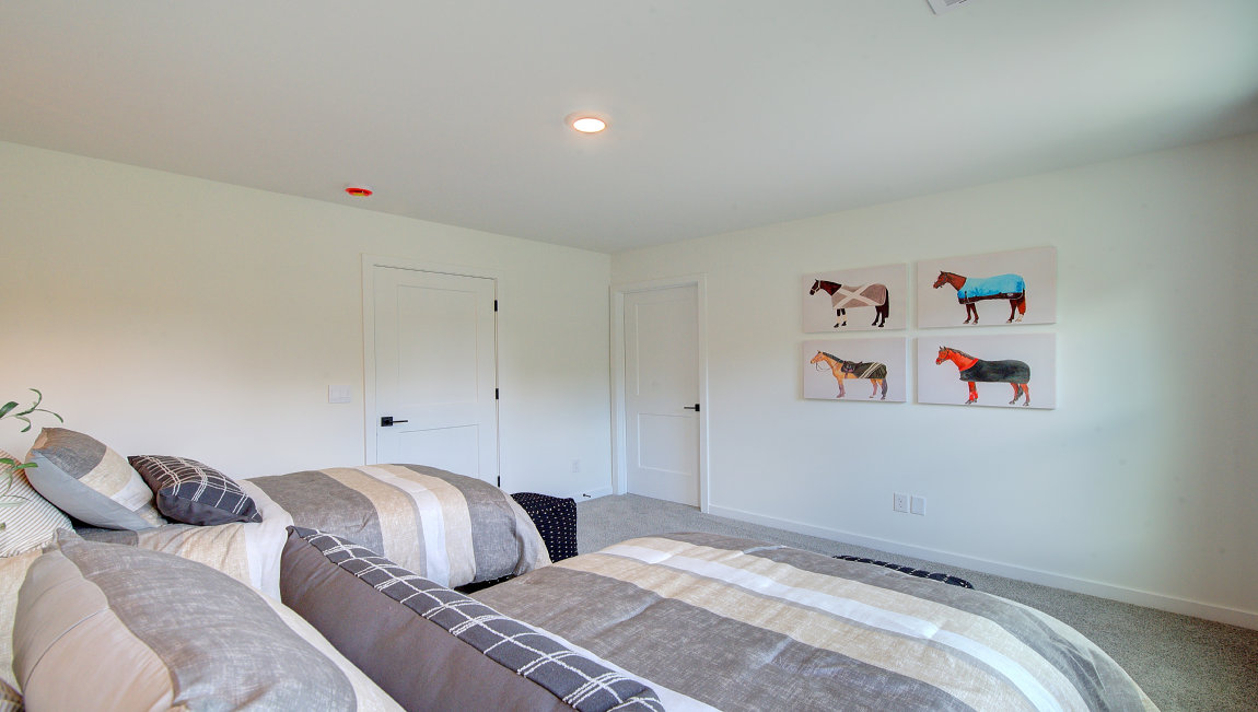 Carpeted bedroom with large windows