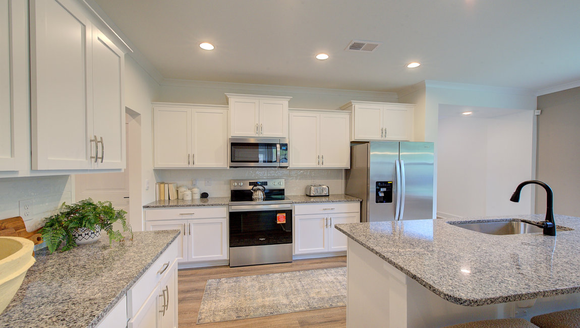 Open concept kitchen with large island and stainless steel appliances