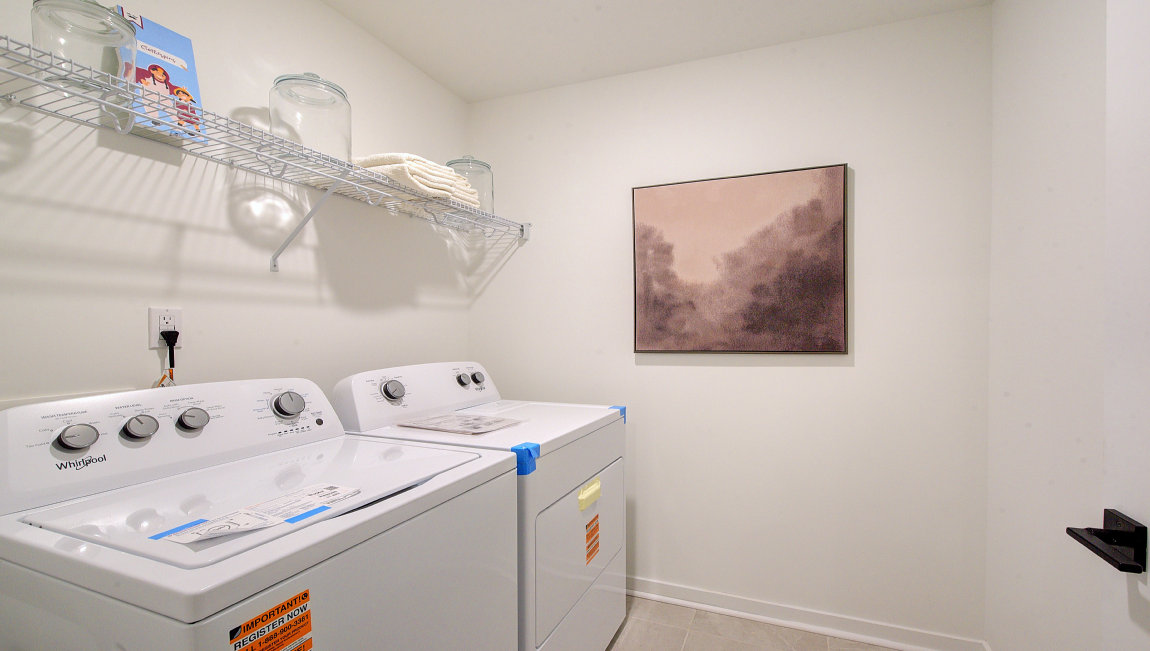 Laundry room with washer, dryer and shelving