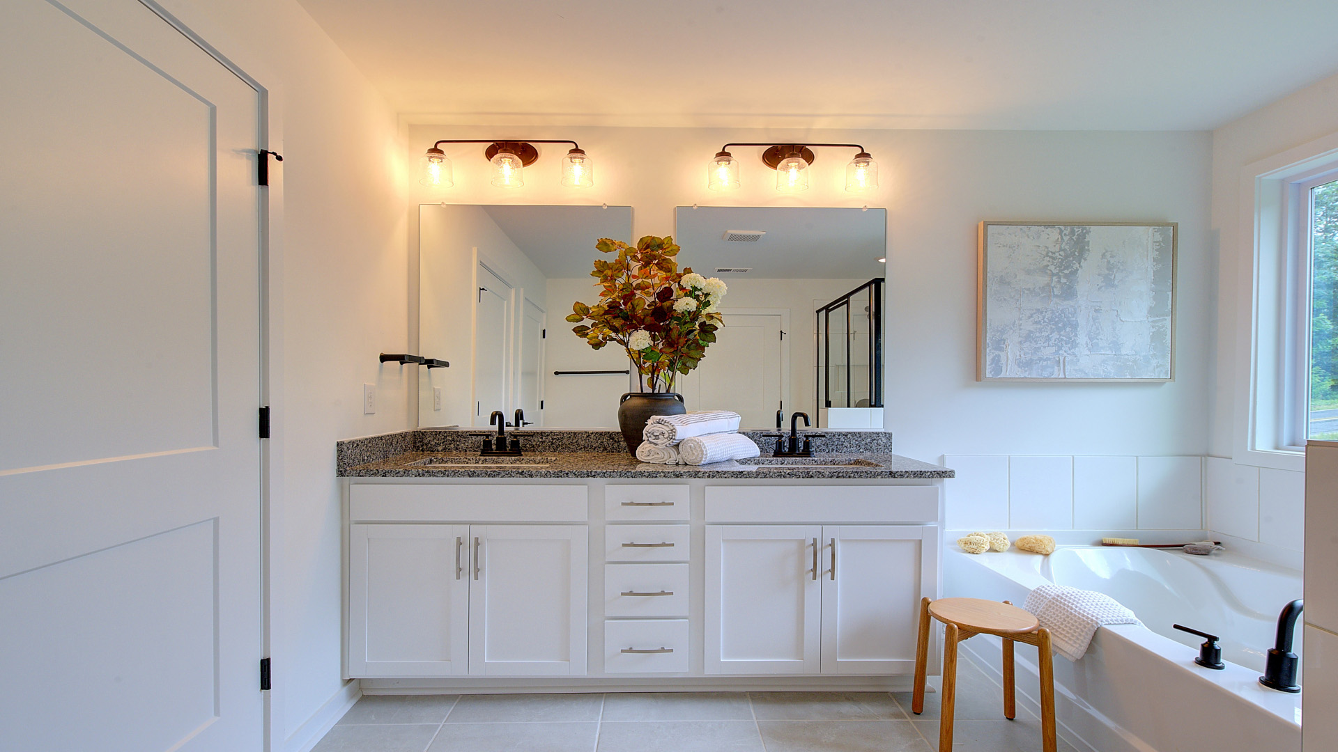 Primary bathroom with walk in shower, dual vanity and garden tub