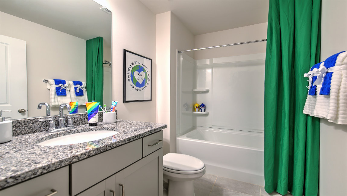 Bathroom with dual vanity and bathtub