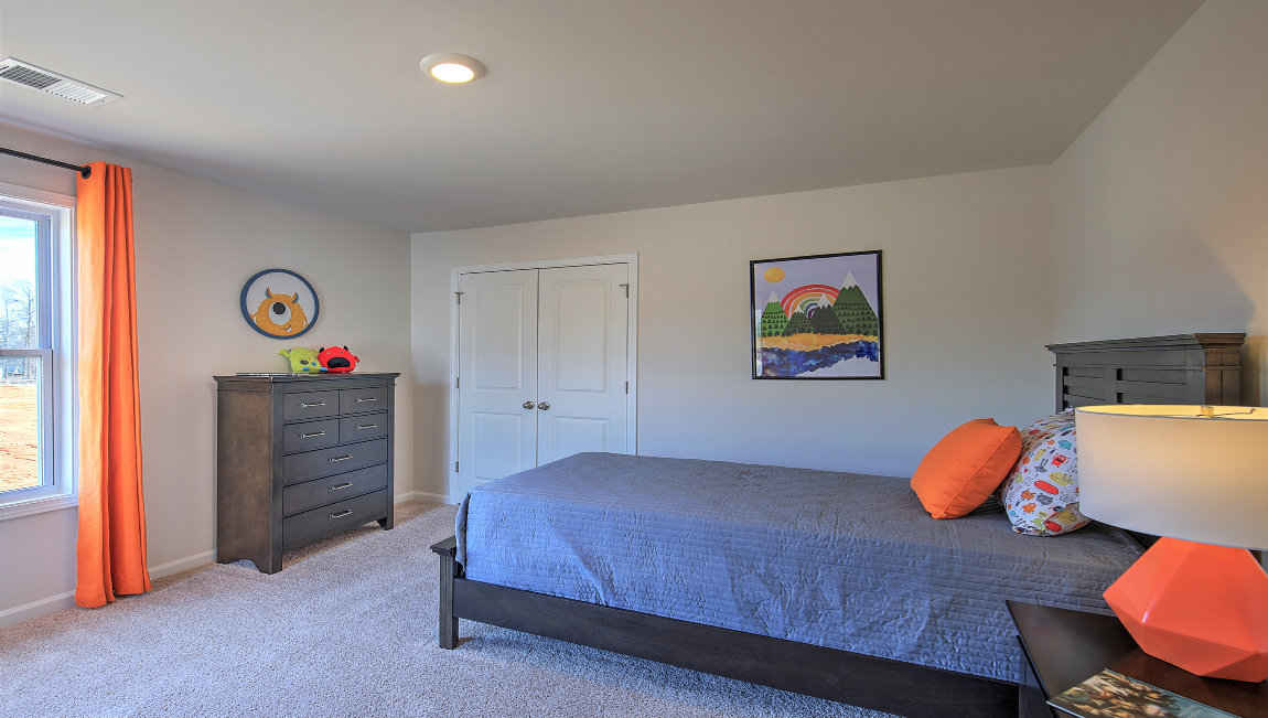 Carpeted bedroom with large windows