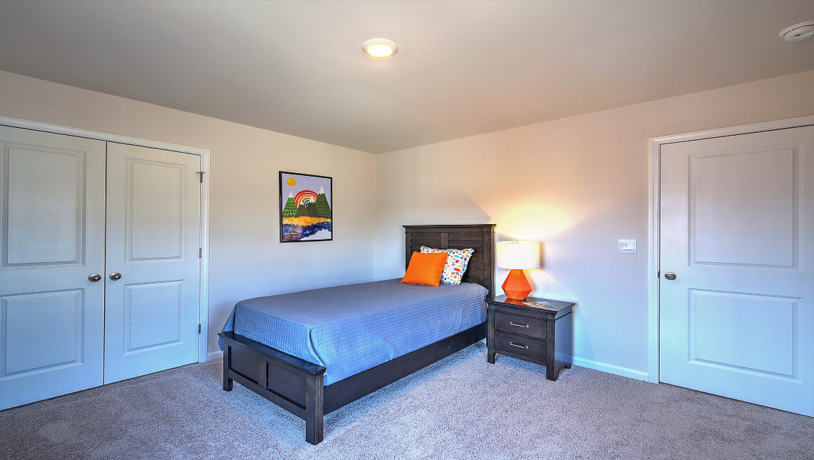 Carpeted bedroom with large windows