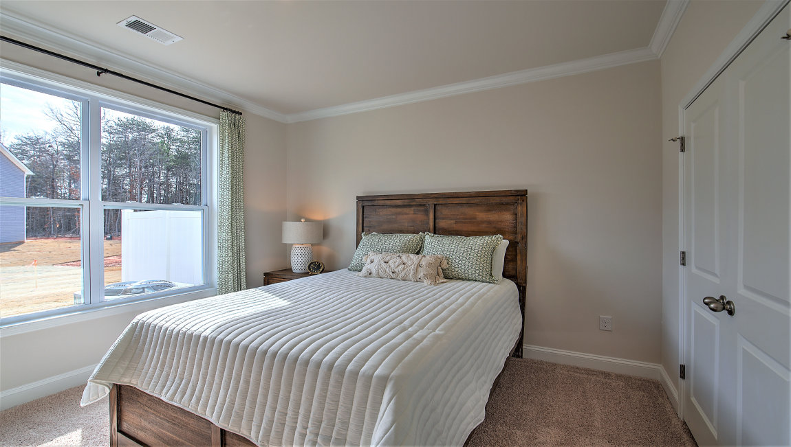 Carpeted bedroom with large window