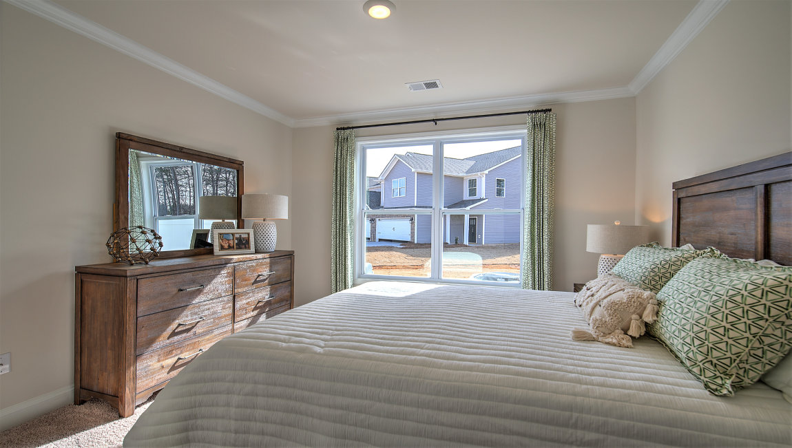 Carpeted bedroom with large window