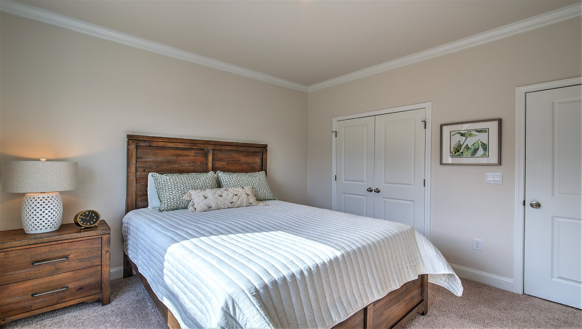 Carpeted bedroom with large window