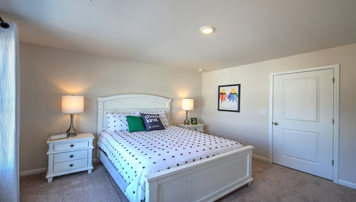 Carpeted bedroom with large window