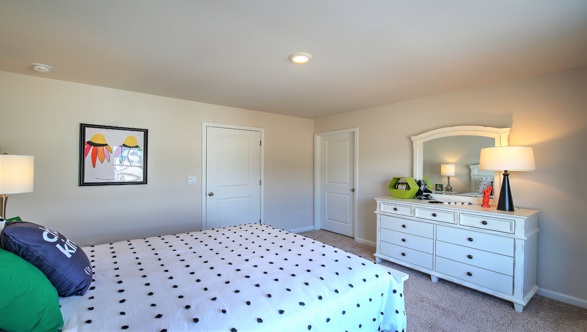 Carpeted bedroom with large window