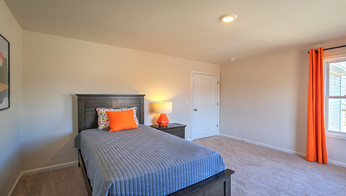 Carpeted bedroom with large window